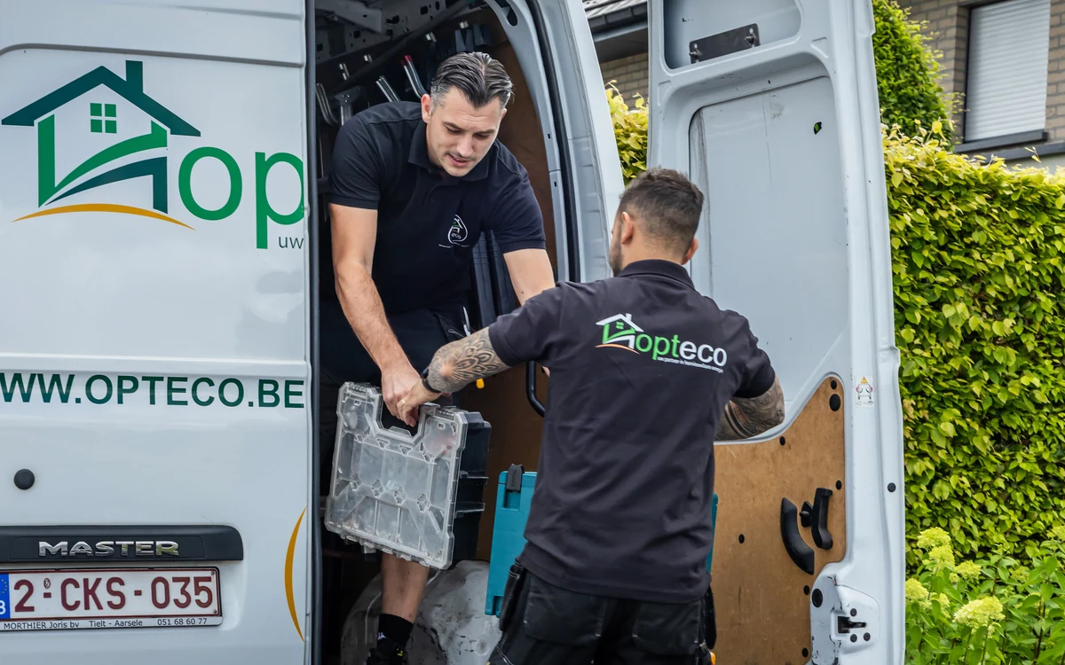 Opteco installateurs laden installatiemateriaal uit de bestelwagen